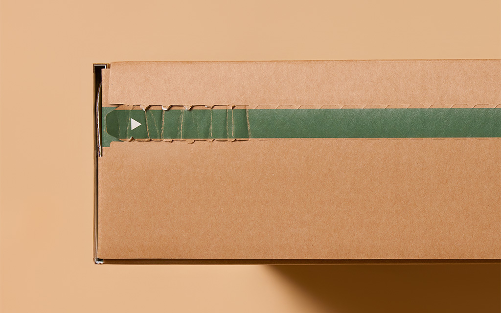 Perforated tear strip on corrugated box engineered with structural packaging engineering.