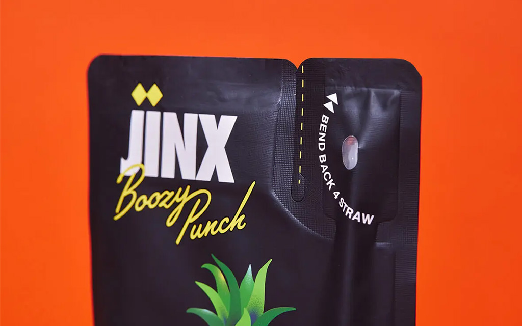 Jinx Drinx pouch with bend-back straw tab engineered using structural packaging engineering.