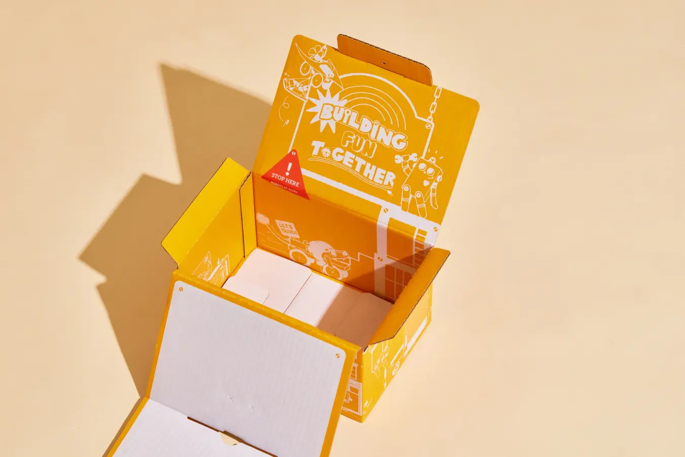 Open colorful packaging for kids' toys with fun robot-building graphics.
