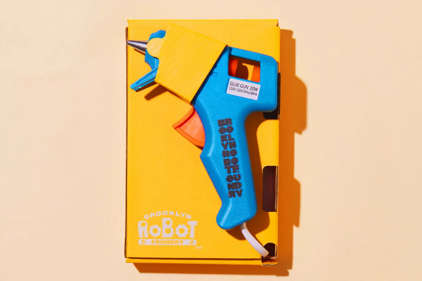 Educational toy packaging with a blue glue gun, part of Brooklyn Robot Foundry kit
