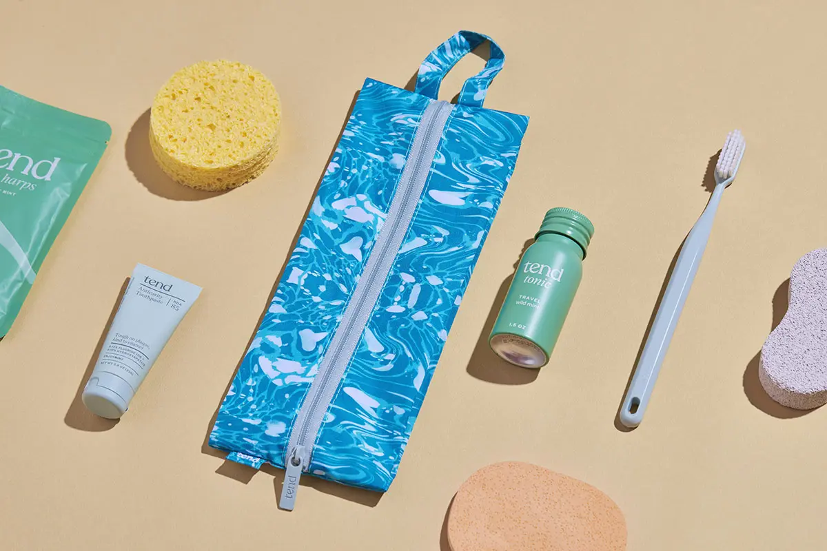 Arrangement of Tend oral care products with modern packaging on a warm background.