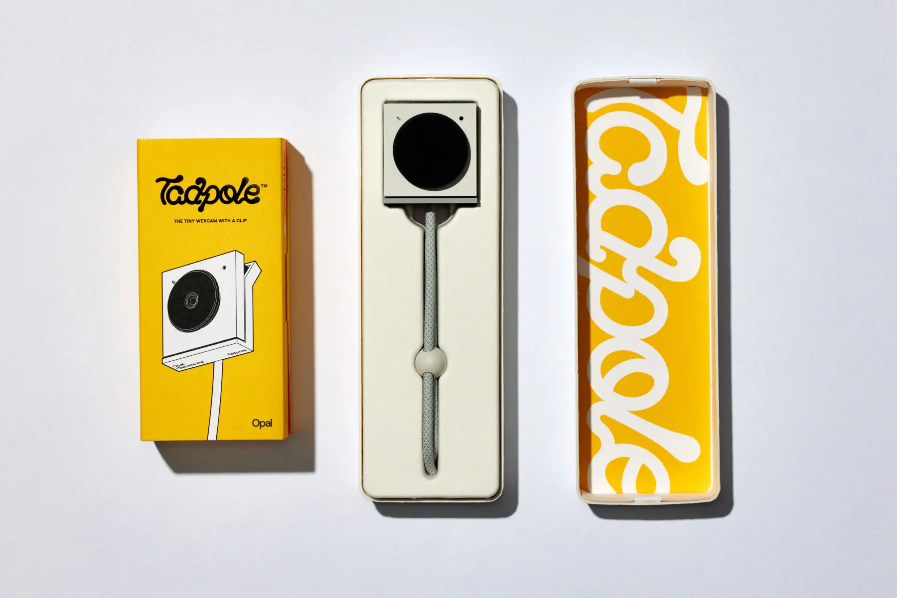 Opal Tadpole webcam packaging design by Zenpack featuring yellow outer box, molded pulp inner tray, and webcam with cable.