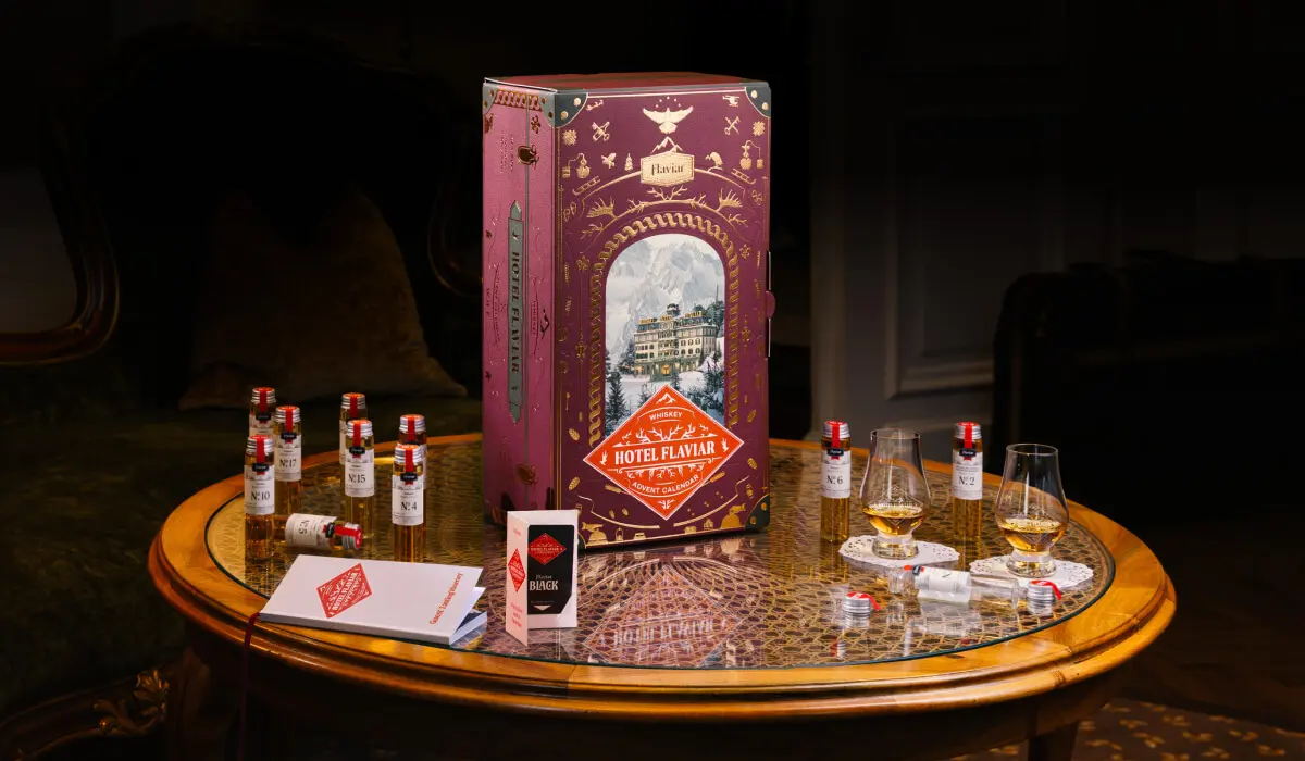 Custom luxury whiskey advent calendar packaging designed by Zenpack, featuring a large detailed "Hotel Flaviar" box and sample bottles, illustrating client success in premium spirit gift set solutions.