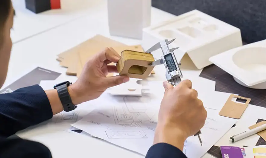Packaging engineer using a digital caliper to measure a prototype insert - Zenpack, your One-stop Packaging Partner