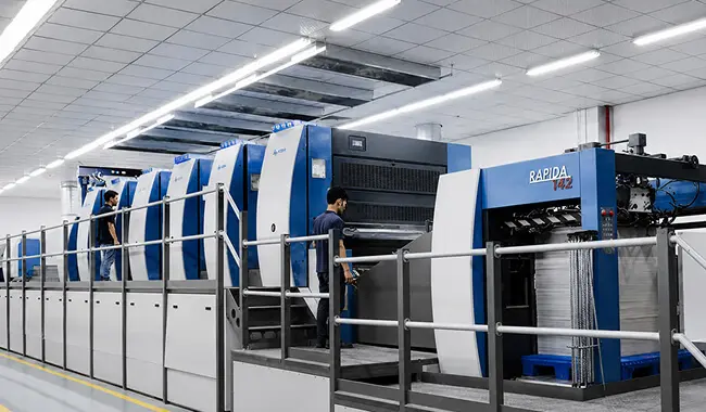 High-speed multi-color offset printing press in Zenpack's manufacturing facility.