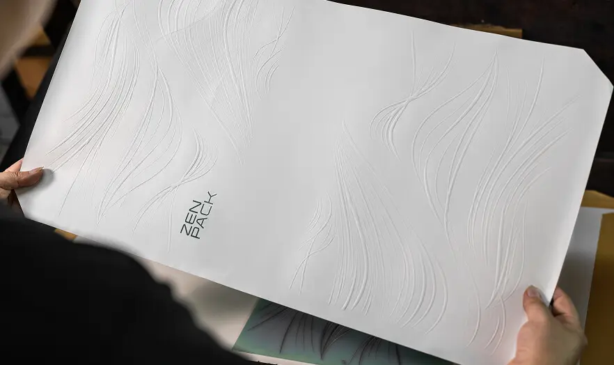 Precision embossed paper sheet with Zenpack logo produced by ISO-certified advanced packaging manufacturing.