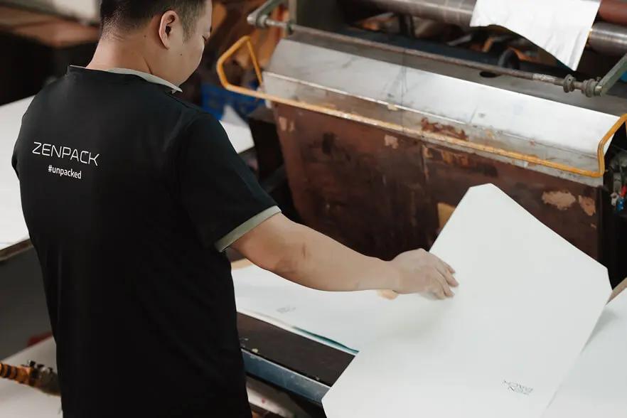 Zenpack in-house manufacturing operator managing quality control for custom packaging.