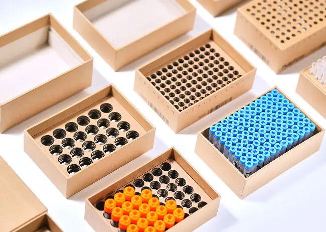 Sustainable paperboard box redesign with custom grid inserts for vial packaging by Zenpack.