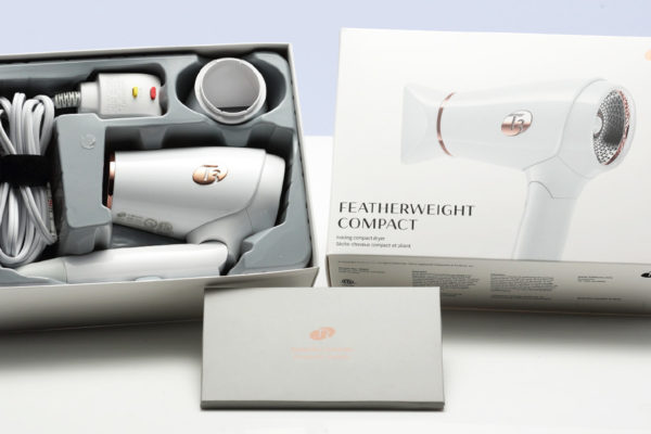 Sleek hair dryer packaging with a modern design, showcasing the Featherweight Compact model and accessories.